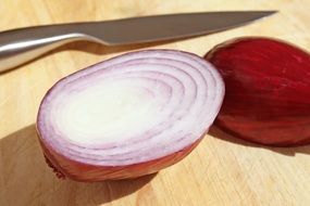 knife near the cut onions on the table