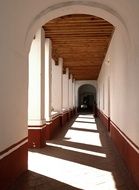arched passage in the monastery in the sunlight