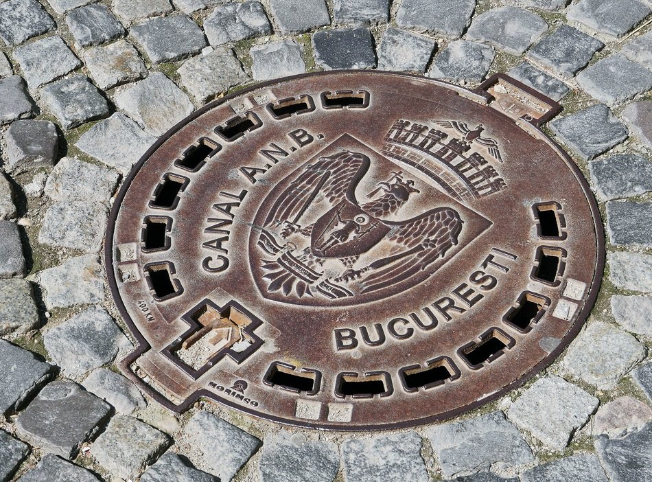 coat of arms of bucharest on the hatch on the pavement