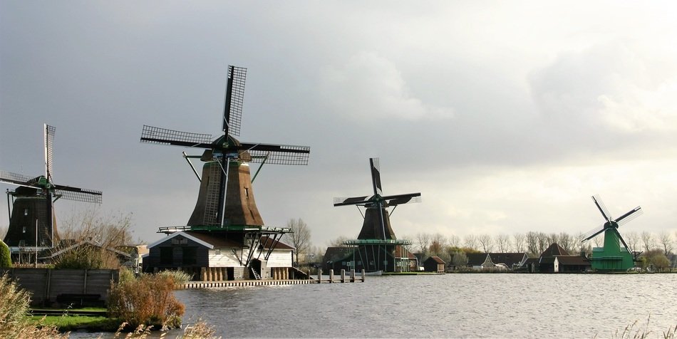 old windmills on the colorful shore by the lake