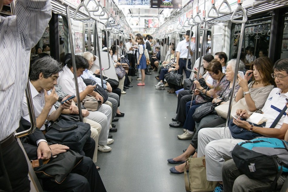 people ride the subway in Tokyo