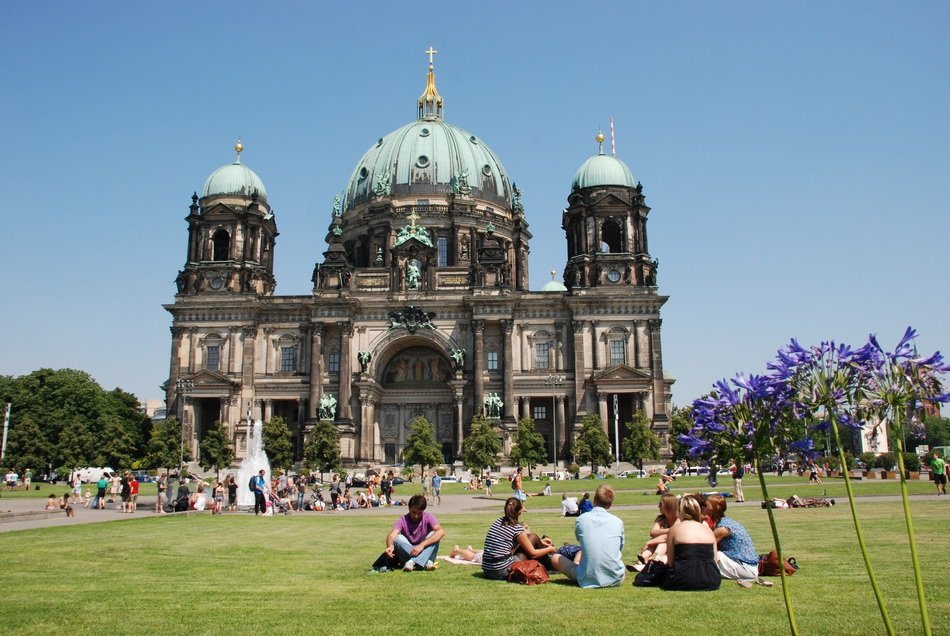 tourists on the lawn near the Berlin church