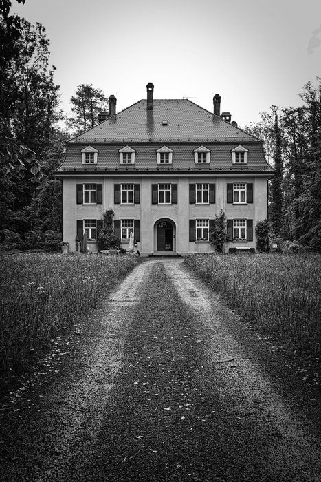 black and white photo of the road to the residence