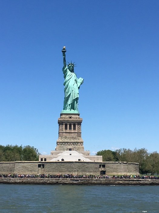 distant view of the statue of liberty on a sunny day