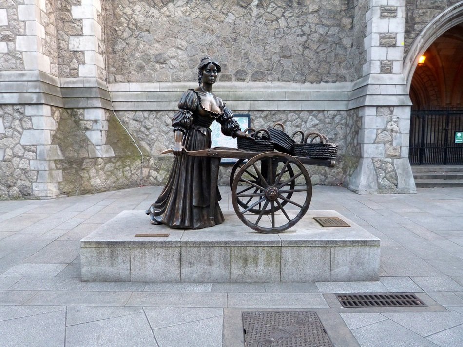 statue of a woman near a cart in dublin