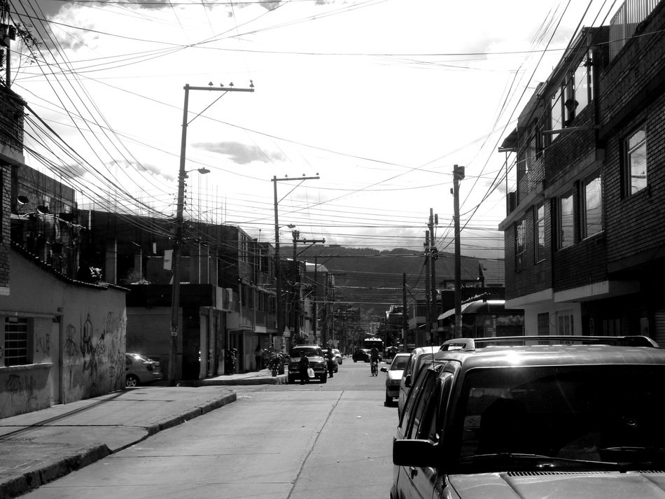 black and white photo of cars on the street in colombia