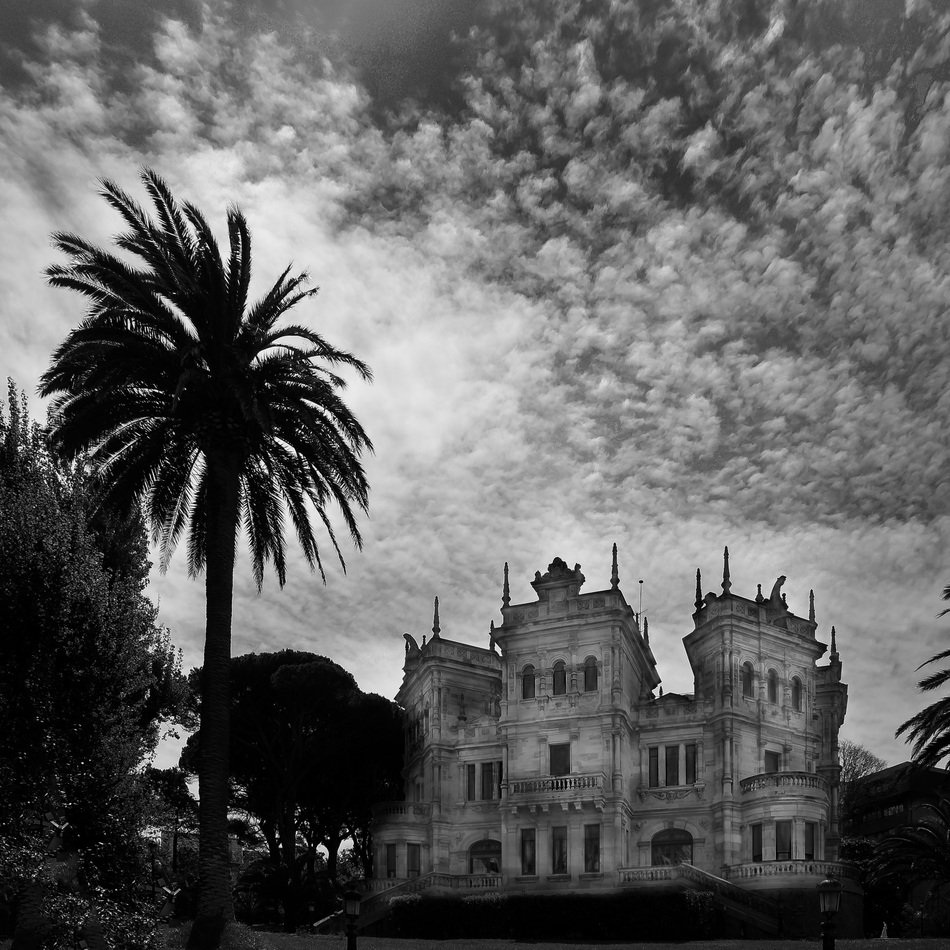 clouds over a mansion in santander in black and white image