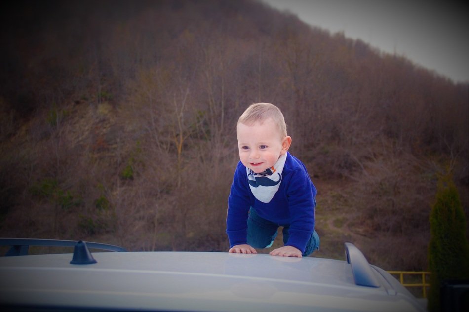 crawling baby boy at the background of forest