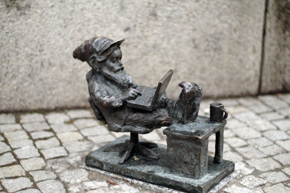 figurine gnome with a laptop on the street of the old city