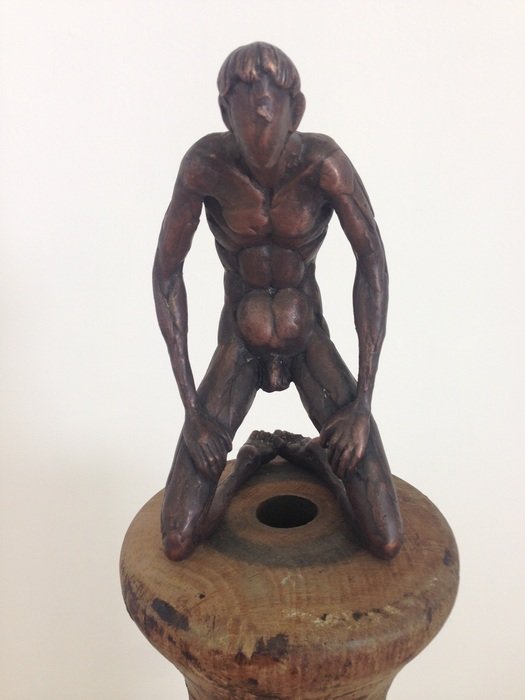 wooden sculpture of a man at the exhibition