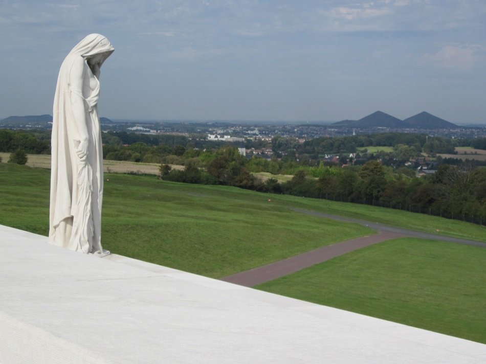 white memorial on a green hill
