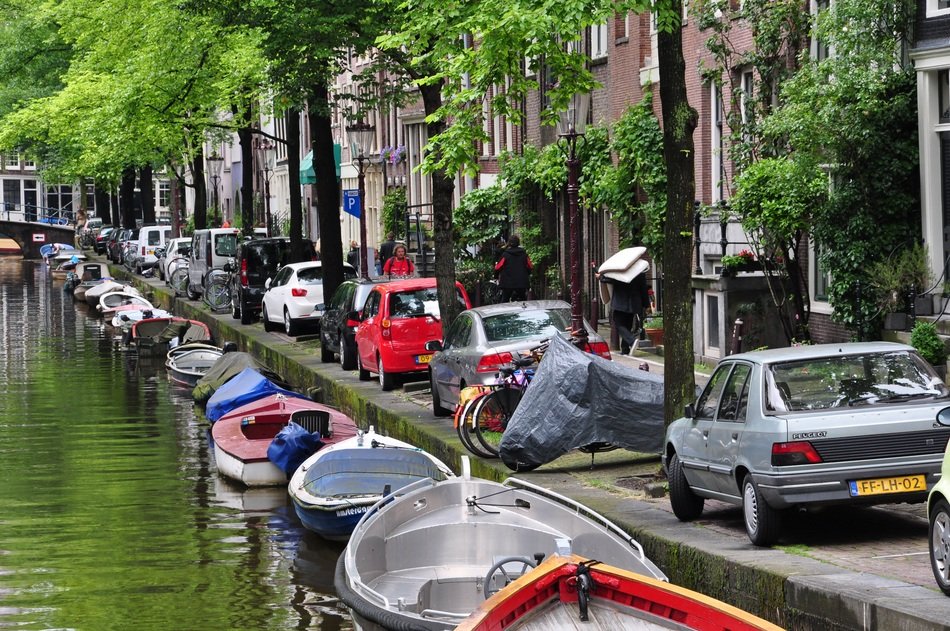 parked boats and cars on the streets of Amsterdam