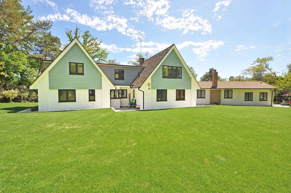 New England style home with the garden