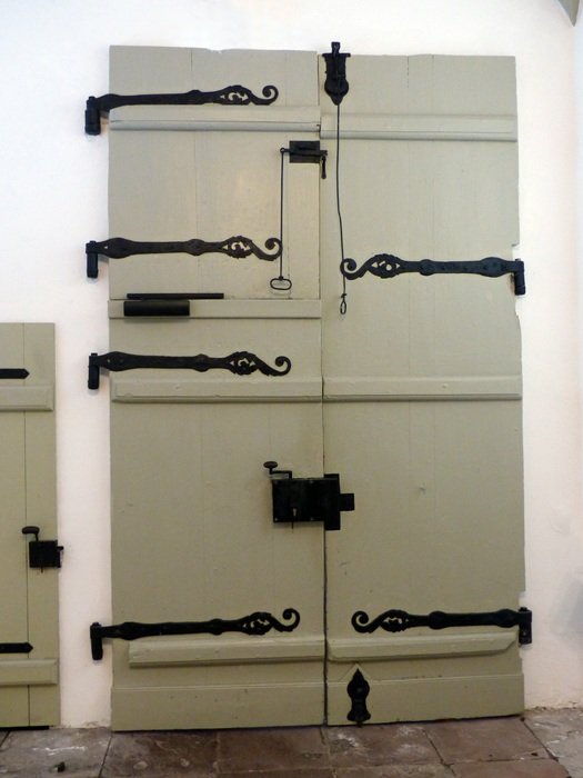 white wood door with large lock