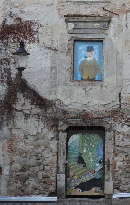 drawings on the windows and doors of the gray building