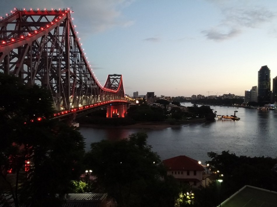 bridge with lanterns near the river at night