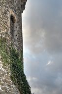 cloudy sky over the old stone tower