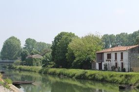 panoramic view of a house on the river bank in the countryside in france