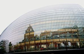 reflection of a building in the mirrored dome of a skyscraper