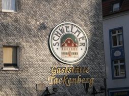 street Sign of Beer Restaurant on wall of house