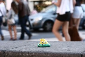 toy martian on a city street