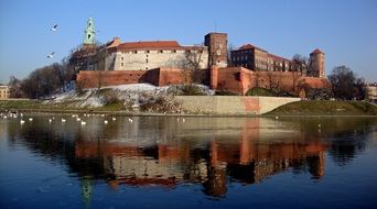 reflection of the castle in the water in Krakow