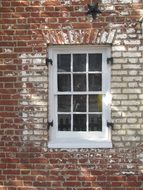 window with bars on the brick wall