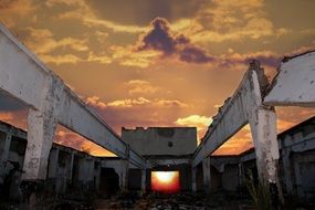 sunset behind the ruins of a building