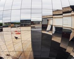 street reflection in the facade of the Bristol Planetarium