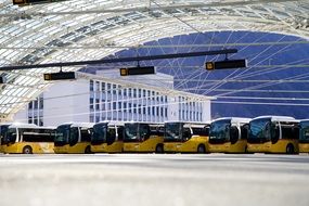 large metal canopy over yellow buses