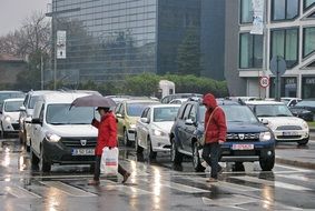 people cross the street in the rain in Budapest