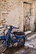 blue motorcycle near the old building