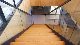 glass railings along a wooden staircase