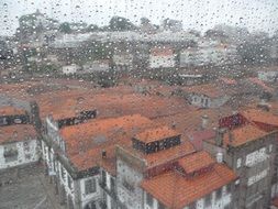 panorama of the old city through a wet window in the rain