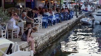 people in a cafe in the harbor in california