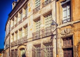 metal grids on the windows on the facade of a building in France