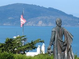 statue of a woman near the american flag