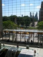 central park reflected in a glass facade in new york