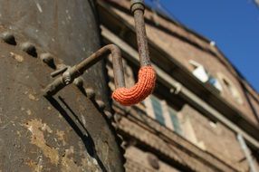 closeup picture of yarn on a rusty pipe