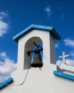 bell and cross of orthodox Church at Blue sky, Cyprus, Paralimni