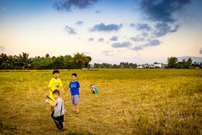 young children play in the field