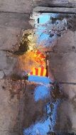 flag reflected in a puddle