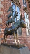 sculpture of Bremen musicians near the brick wall in Bremen