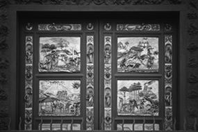 black and white photo of the door with a picture in the temple, florence