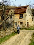 man on the street with poor houses