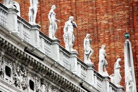 white statues on a historic building