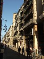 people on a city street in Barcelona on a sunny day