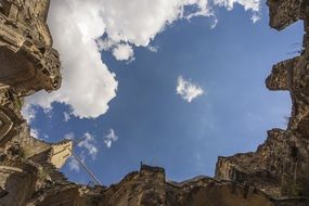 castle ruins under a blue sky with white clouds