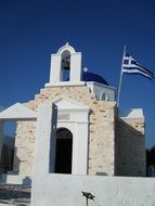 orthodox church with greece flag on a sunny day