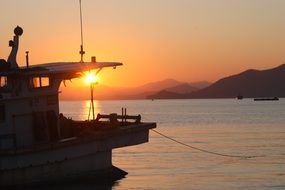 ship at the pier on the background of sunset